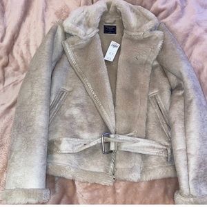 very cute nude coat in size small and never worn.